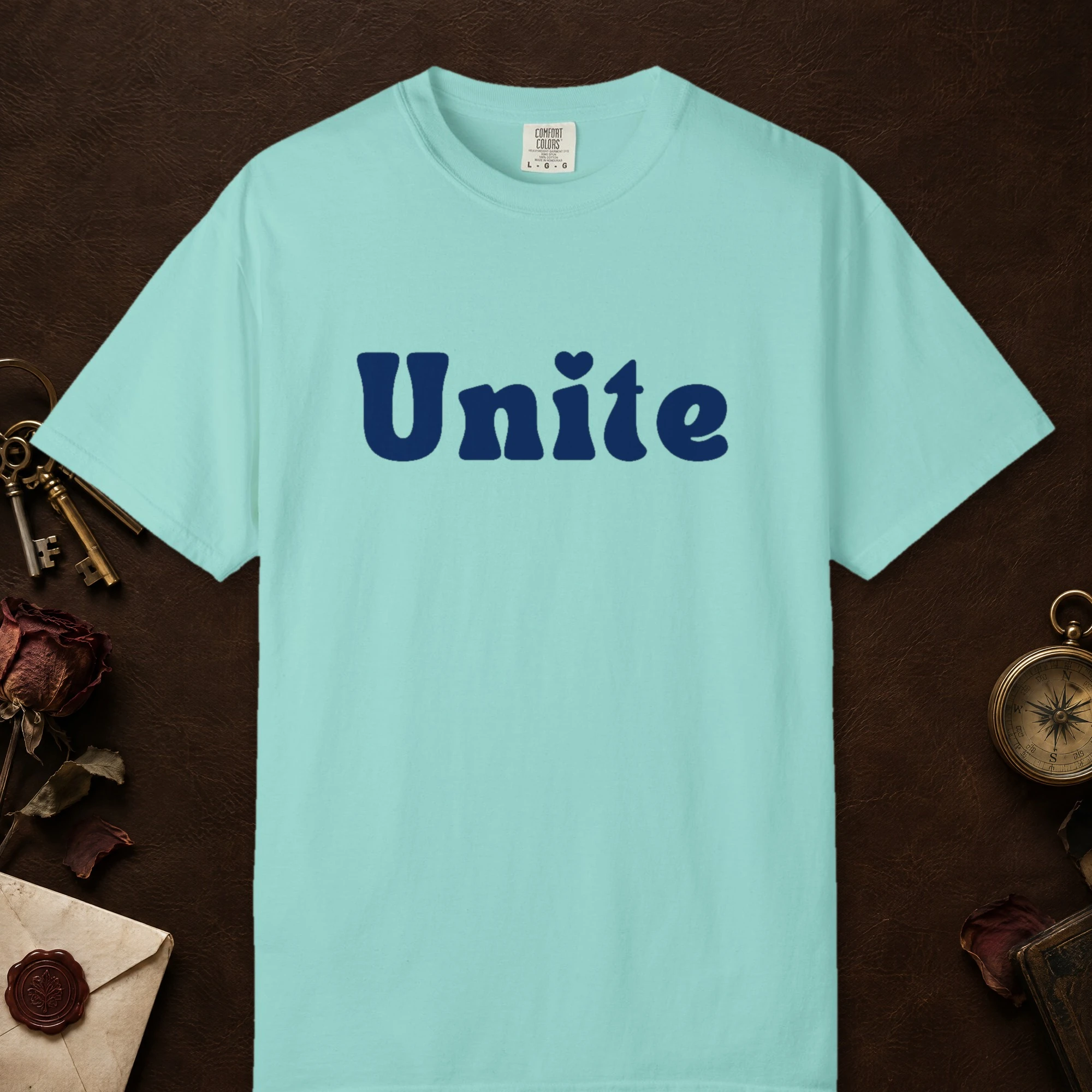 Unite design on a Chalky Mint Comfort Colors 1717 tee, laid flat