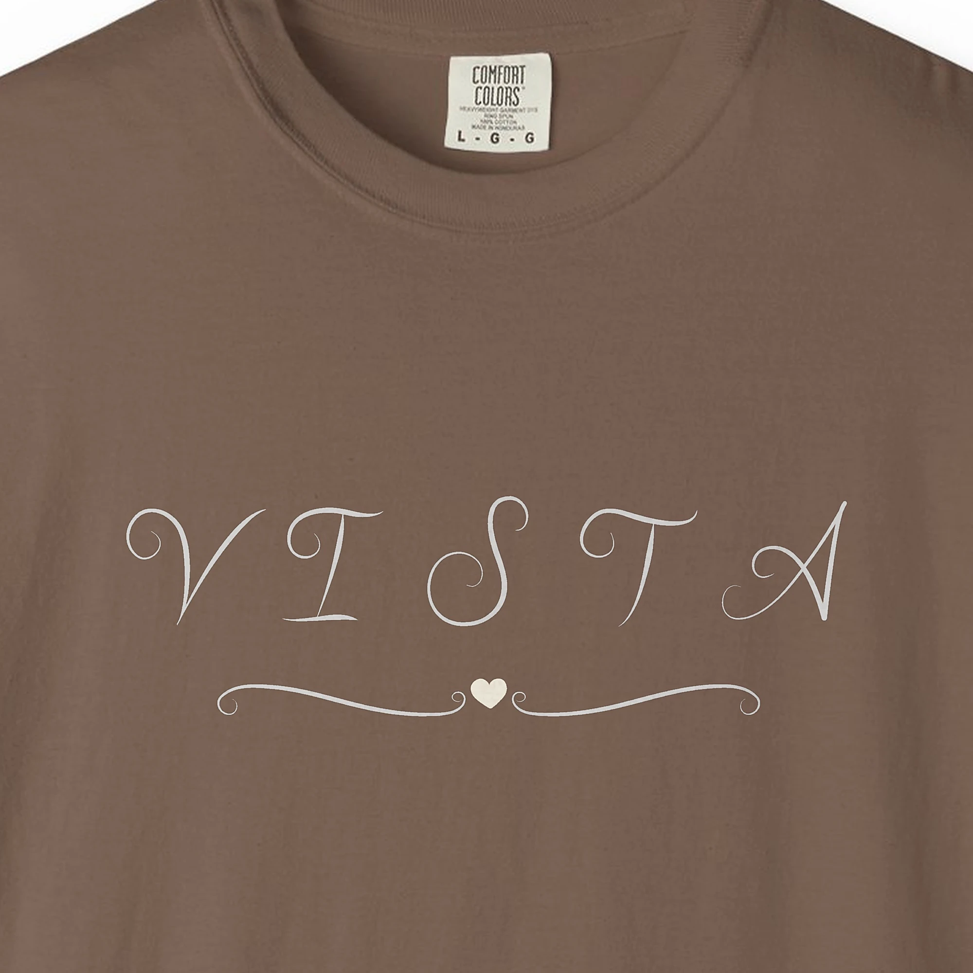 Close-up of the Vista Swirl Heart print on a Espresso Comfort Colors 1717 tee