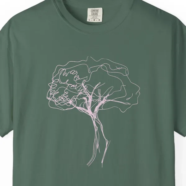 Close-up of the Windswept Tree print on a Blue Spruce Comfort Colors 1717 tee