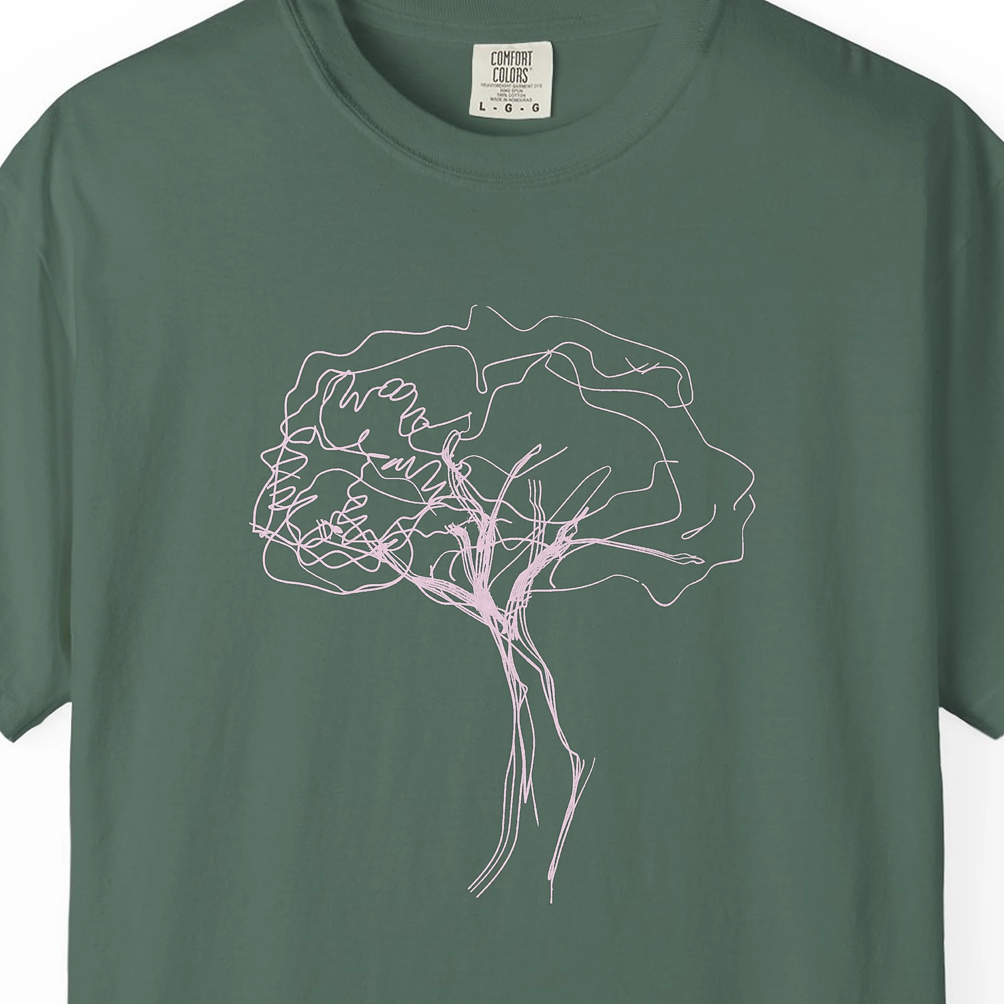 Close-up of the Windswept Tree print on a Blue Spruce Comfort Colors 1717 tee