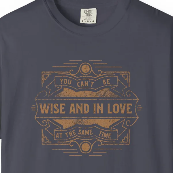 Close-up of the Wise and in Love print on a Navy Comfort Colors 1717 tee