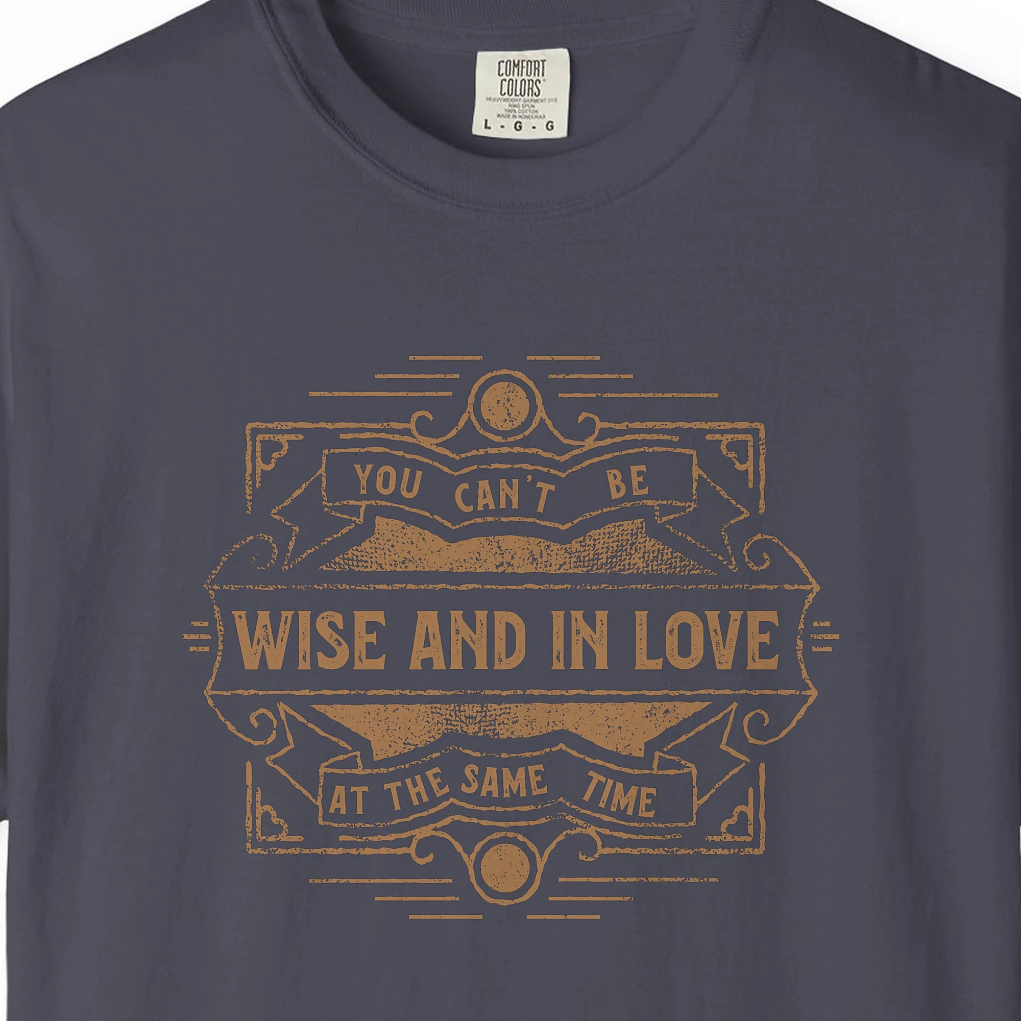 Close-up of the Wise and in Love print on a Navy Comfort Colors 1717 tee
