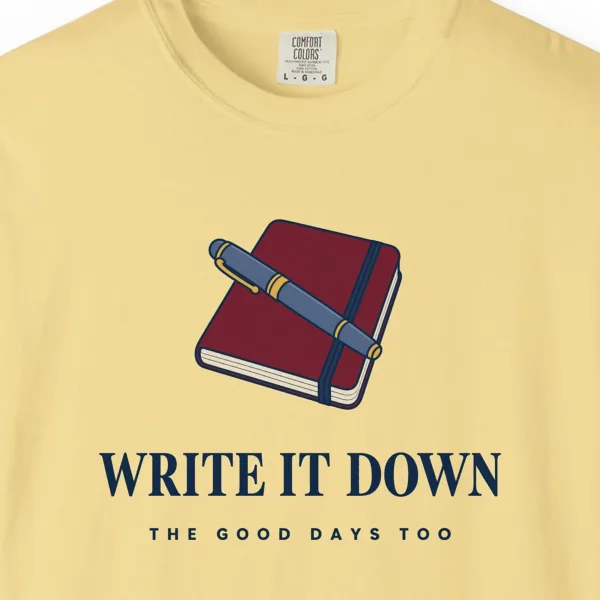 write-it-down-tee-butter-chest Close-up of the Write It Down print on a Butter Comfort Colors 1717 tee