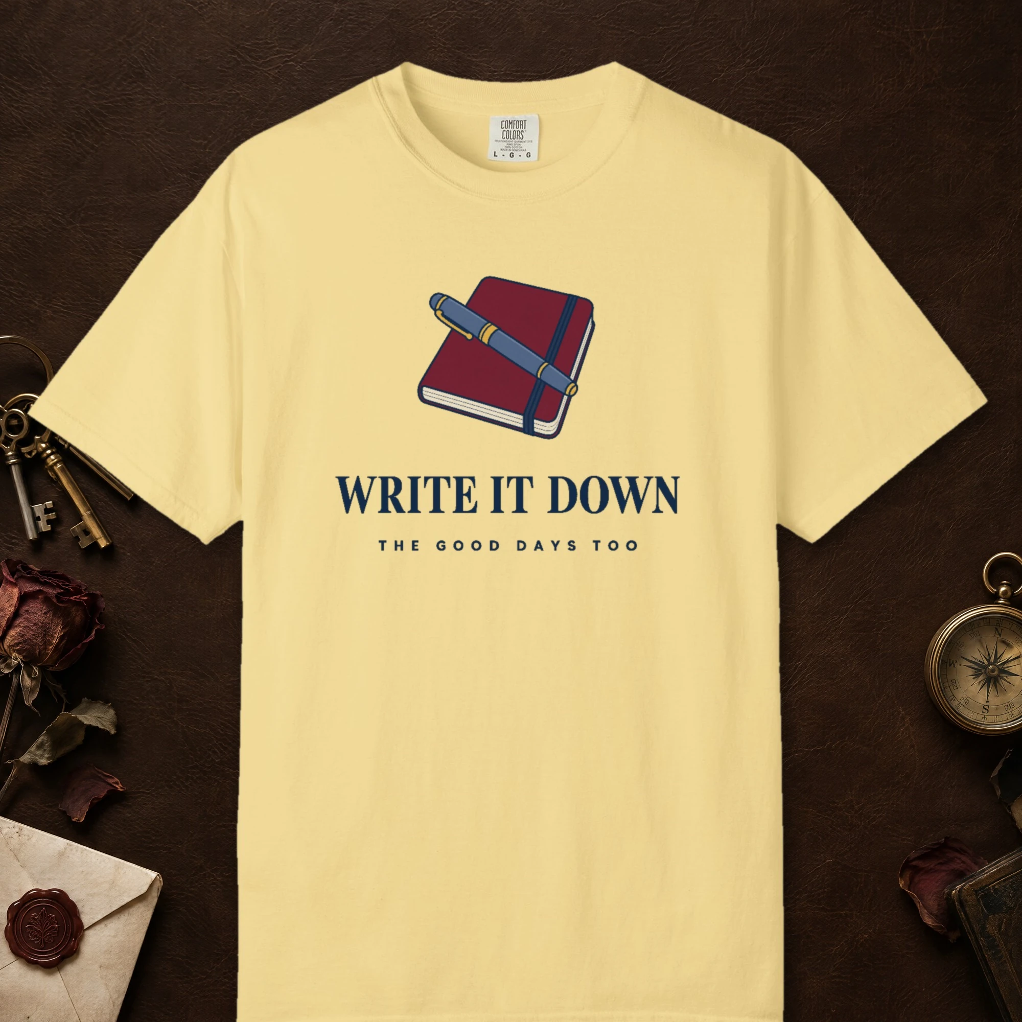 Write It Down design on a Butter Comfort Colors 1717 tee, laid flat